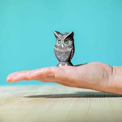 Image of the owl toy being painted with watercolors by a child.