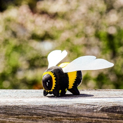 Close-up of wooden bumblebee on a yellow flower