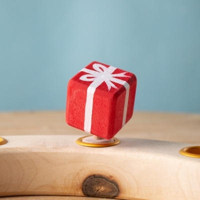 Festive Gift displayed on wooden celebration ring.