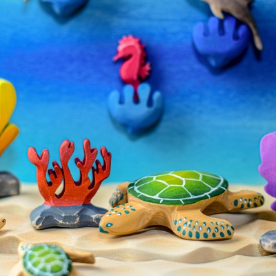 Child's hands holding the Seahorse, showing its detailed craftsmanship