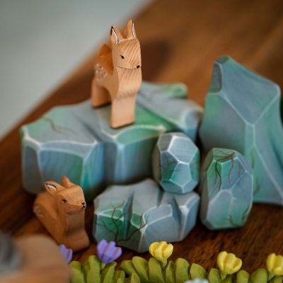A collage of images showcasing the fawn toy in various settings and play scenarios.