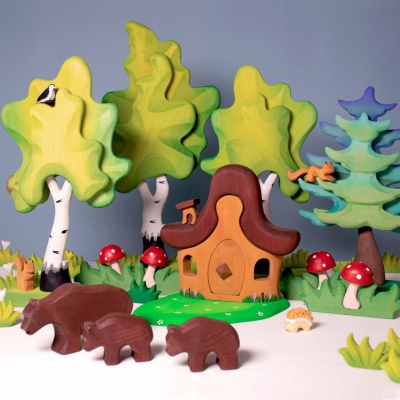 The Mushroom in Grass incorporated into a miniature forest scene with other small toys.