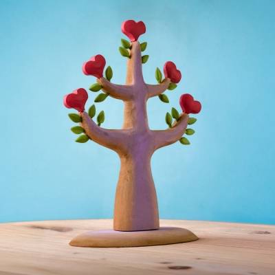 Back view of the wooden heart tree showing the continuous hand-carved trunk texture and sturdy base.