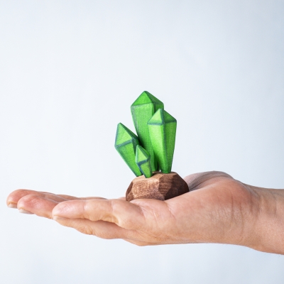 Hand holding a green crystal cluster toy to show scale and texture.