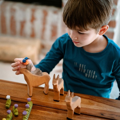 Wooden deer herd, celebrating wildlife with sustainable toys.