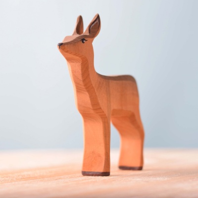 Artisanal wooden deer toy with a non-toxic finish.