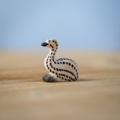 Handmade sitting emu chick toy on a wooden surface