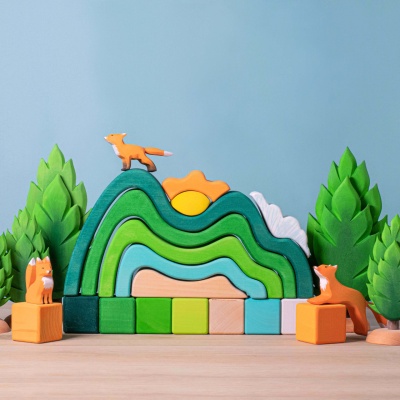 The Sun peeks over wooden mountains in this BumbuToys' picturesque set.