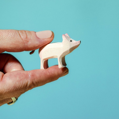 Playful wooden piglet in a standing position from BumbuToys' collection