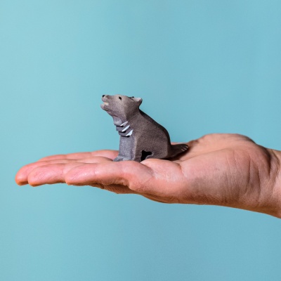 Detailed view of the sitting wolf cub, highlighting artisanal craftsmanship
