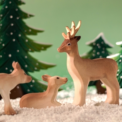Standing Reindeer Calf in a snowy play setting.