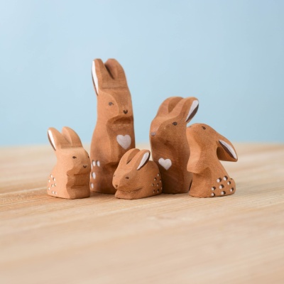 Wooden Rabbit Family SET arranged in a natural play scene.