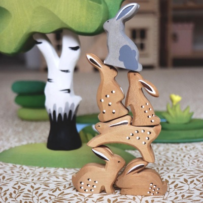 Wooden rabbit toy shown in a group with other animal toys (bear, fox, etc.).