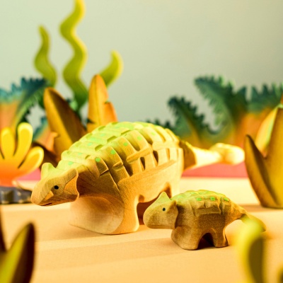 Wooden Ankylosaurus Big and Baby toys in a prehistoric play scene