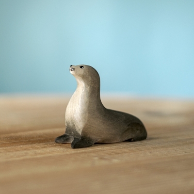 The Curious Harp Seal figure with an upright, alert posture and grey hand-painted details.