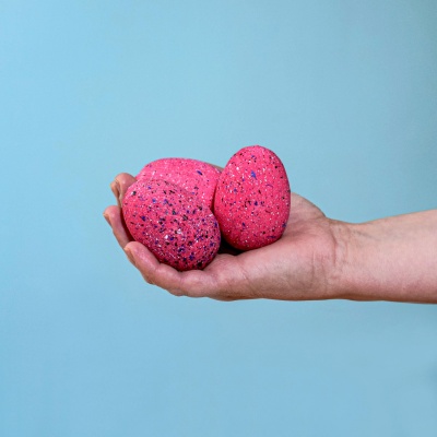 Close-up of Wooden Spinosaurus Eggs held in hand