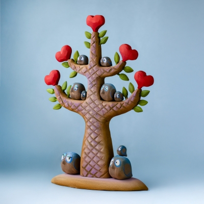 BumbuToys Heartwood Tree display filled with a collection of medium and large wooden bluebirds.