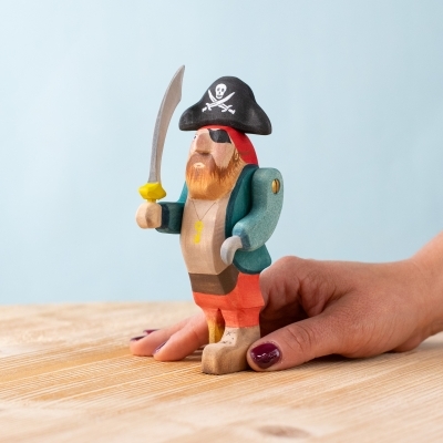 Wooden pirate toy held by hand to show size and detail