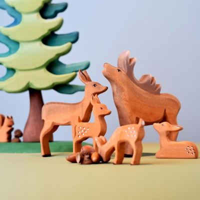 The wooden stag toy displayed on a shelf in a child's room.
