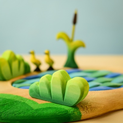Lake Bush toy in a play scene with other wooden toys.