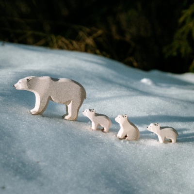 The Polar Bear nestled amongst other BumbuToys Arctic animal toys like a fox or walrus.