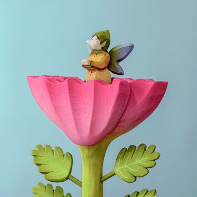 Wooden toy of an elf with wings and guiding lantern.