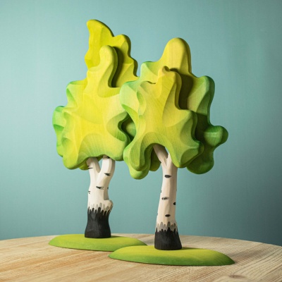 The handcrafted birch tree figures from BumbuToys, with lively green leaves, bring the beauty of nature indoors.