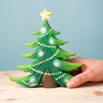 Wooden Christmas Tree shown in hand for scale.
