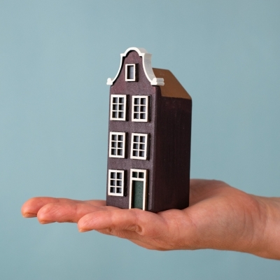 Amsterdam House shown in hand for scale.