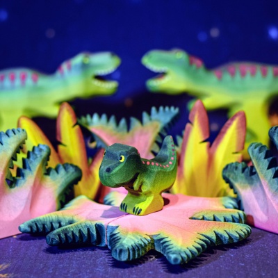Close-up of the wooden T-Rex Baby toy with non-toxic paint