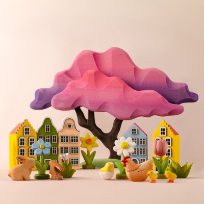 Magical spring playroom scene with a pink wooden tree, houses, animals, and a tulip