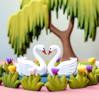 Swans afloat on love's lake, a wooden set that celebrates romantic beauty.