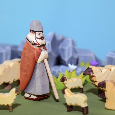 The warm, natural wood grain of the lamb figurine accentuated by natural light.