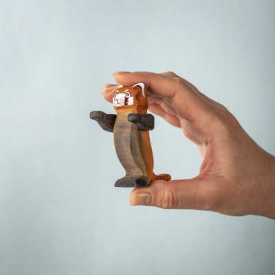Red panda toy held in hand showing its expressive shape