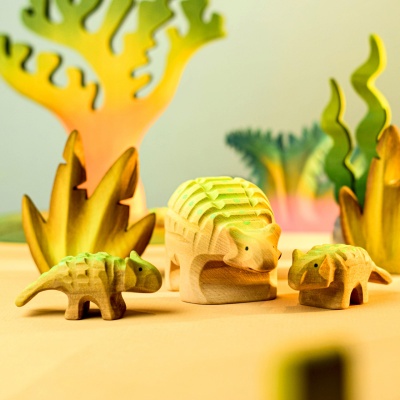 Montessori and Waldorf-inspired Wooden Ankylosaurus Set in a natural play setting