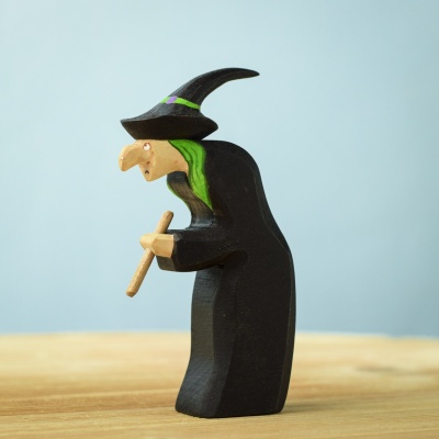 Handcrafted wooden brewing witch standing alone.
