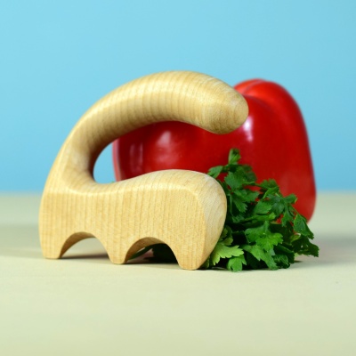 Side view of the wooden salad spatula with parsley