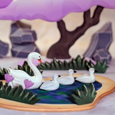 Swans afloat on love's lake, a wooden set that celebrates romantic beauty.
