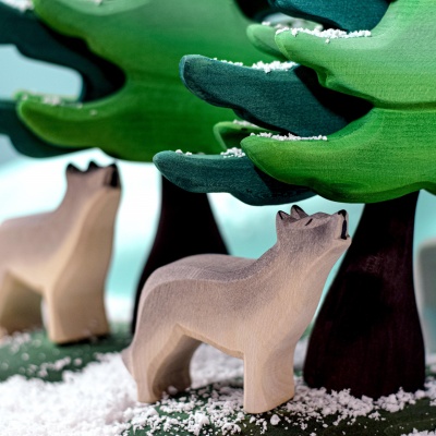 Howling Wolf peering out from behind a tree.