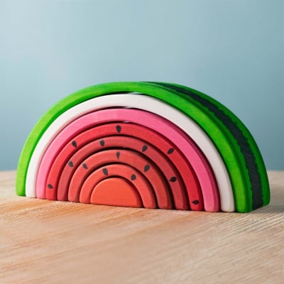 Vibrant wooden watermelon slices by BumbuToys, ready to be stacked and played with.
