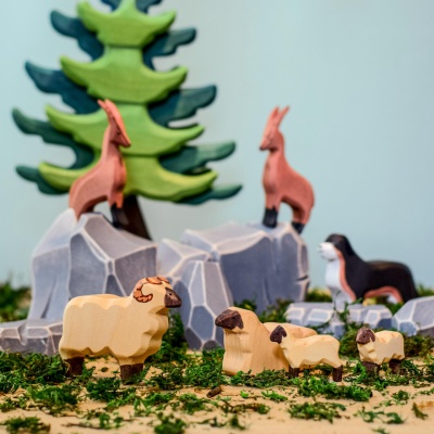 The lamb figurine featured alongside other Bumbu Toys animal figurines, showcasing a barnyard collection.