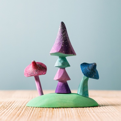 Handcrafted and glitter-coated wooden mushrooms by BumbuToys, perfect for magical play