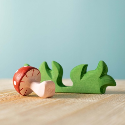 The toy photographed beside other BumbuToys wooden animals.