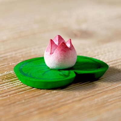 BumbuToys' Water Lily, a wooden figure with a soft pink bloom atop a bright green lily pad.