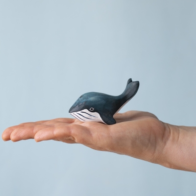 Baby Blue Whale toy resting in a child's palm