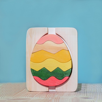A stackable Egg Puzzle from BumbuToys, featuring bright, springtime hues in a playful design.