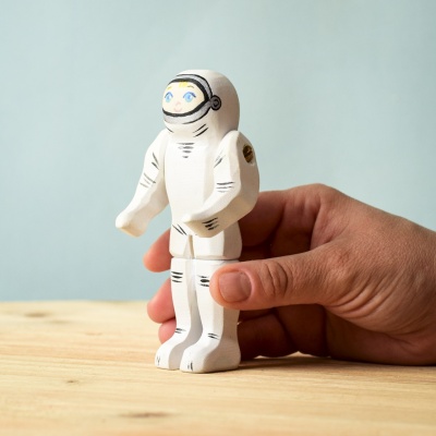 Hand holding the astronaut.