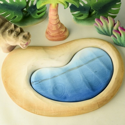 Wooden Savanna Lake toy surrounded by wooden trees and animal figures.