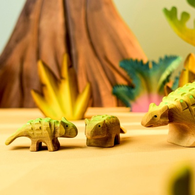 Wooden Ankylosaurus family in a detailed dinosaur-themed setup