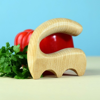Child-friendly wooden salad spatula next to a red bell pepper